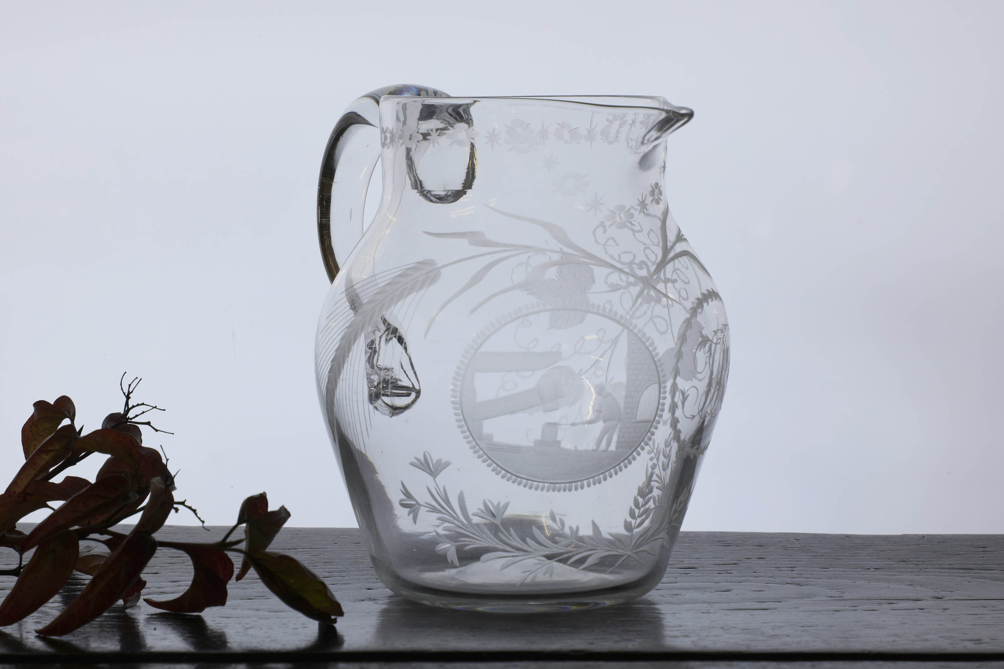 Lot 312 An engraved glass ale jug,