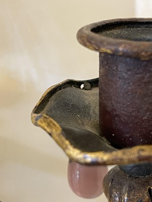 Lot 19 - A pair of metal and gilt-heightened candle sconces