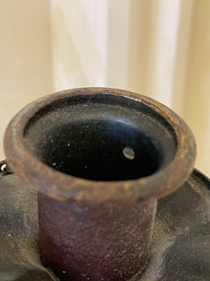 Lot 19 - A pair of metal and gilt-heightened candle sconces