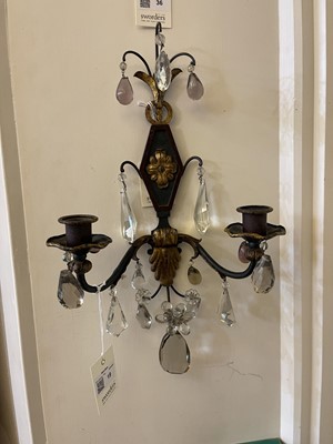 Lot 19 - A pair of metal and gilt-heightened candle sconces