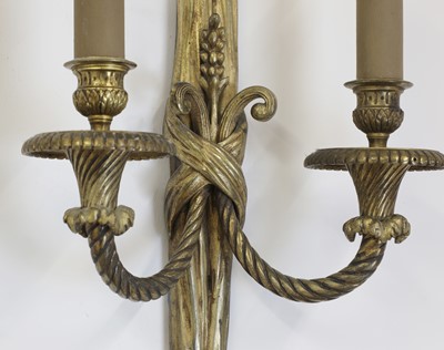 Lot 57 - A pair of gilt-bronze twin-branch wall lights