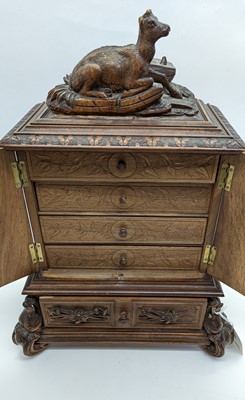 Lot 150 - A Black Forest carved wooden table cabinet