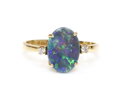 Lot 326 - A three stone black opal and diamond ring