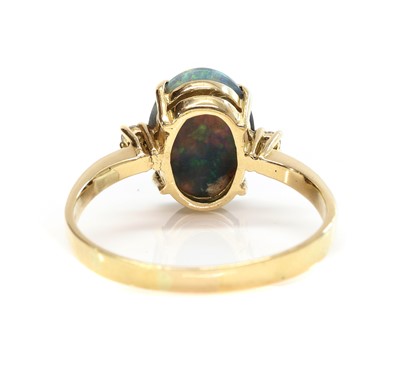 Lot 326 - A three stone black opal and diamond ring