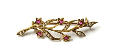 Lot 41 - A gold ruby and split pearl spray brooch