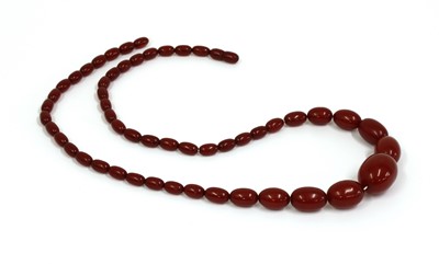 Lot 68 - A single row graduated cherry coloured Bakelite bead necklace