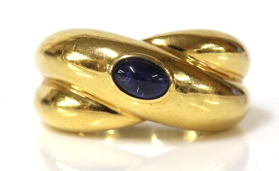 Lot 507 - A single stone sapphire crossover band ring, by Cartier, c.1992