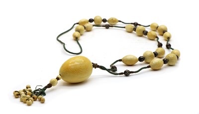Lot 191 - An ivory bead necklace