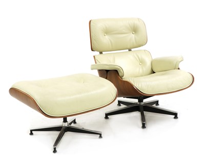 Lot 334 - A Charles Eames style armchair and stool upholstered in cream leather