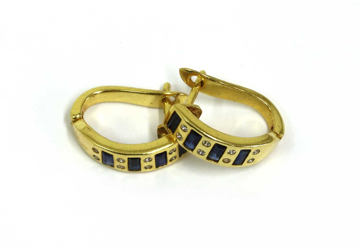 Lot 296 - A pair of gold sapphire and cubic zirconia hoop earrings