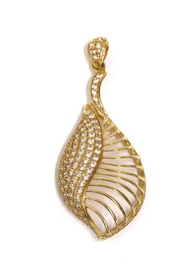 Lot 1113 - A gold cubic zirconia set shell or leaf form pendant