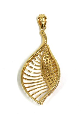 Lot 1113 - A gold cubic zirconia set shell or leaf form pendant