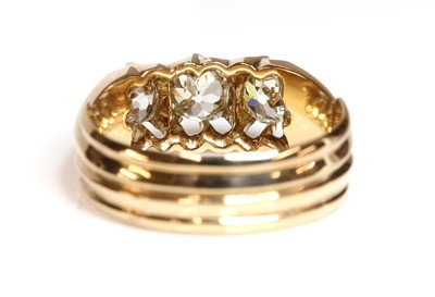 Lot 106 - An Edwardian rose gold three stone diamond ring, c.1905