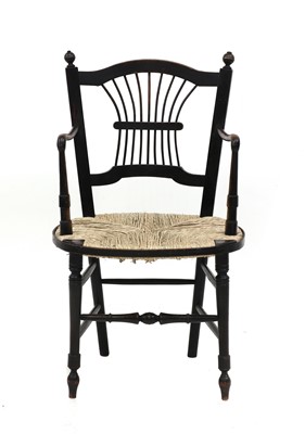 Lot 200 - A Morris & Co. ebonised 'Sussex' elbow chair