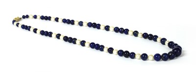 Lot 306 - A single row graduated lapis lazuli bead and cultured pearl necklace
