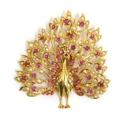 Lot 230 - A gold ruby and split pearl peacock pendant