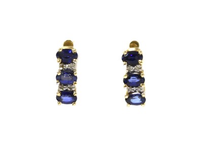 Lot 1222 - A pair of gold sapphire and diamond earrings