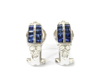 Lot 1214 - A pair of white gold sapphire and diamond half hoop earrings