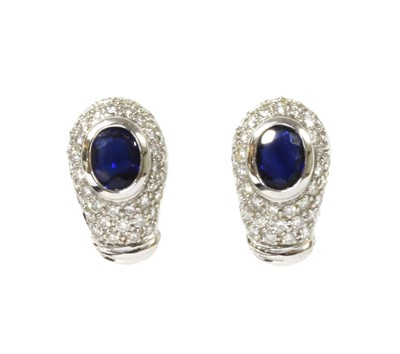 Lot 1212 - A pair of white gold sapphire and diamond earrings
