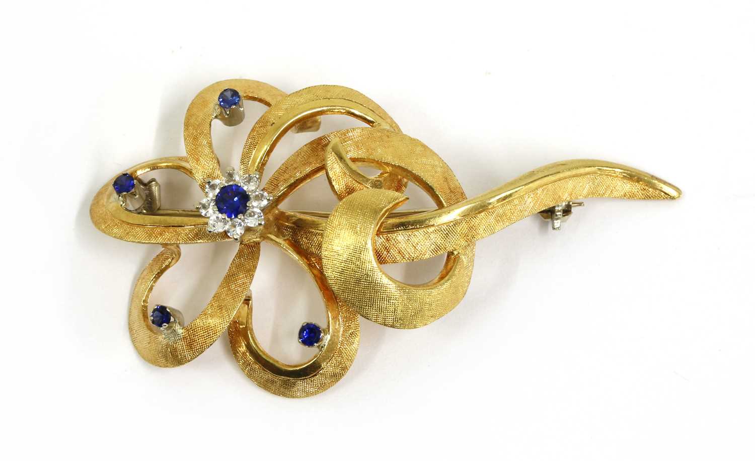 Lot 82 - A gold synthetic sapphire and paste set spray brooch