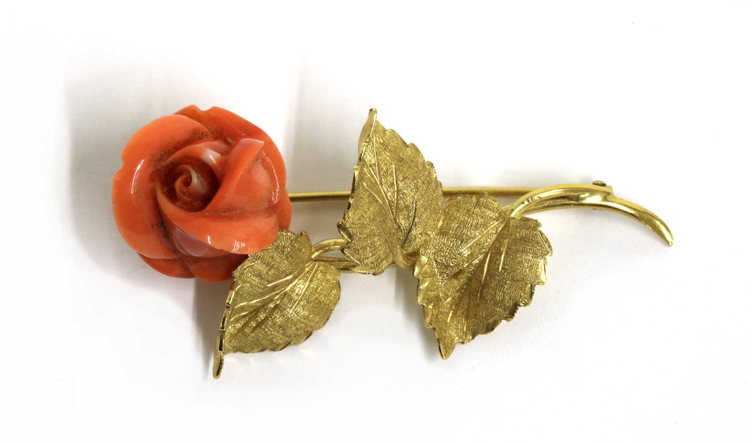 Lot 61 - An Italian gold carved coral brooch