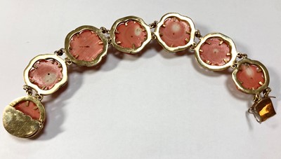 Lot 1073 - A gold carved coral ring and bracelet suite