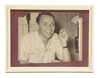 Lot 143 - An autographed photograph by Frank Sinatra at the studio of Radio Luxembourg