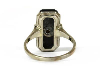 Lot 1065 - A Continental white gold diamond and onyx ring
