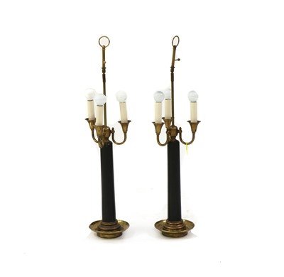Lot 234 - A pair of ebonised wooden and gilt metal table lamps