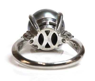 Lot 318 - A cultured Tahitian pearl and diamond ring