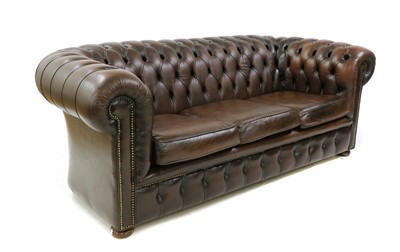 Lot 282 - A brown leather three seater Chesterfield sofa