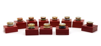 Lot 180 - A complete set of enamelled Halcyon Days Christmas trinket boxes