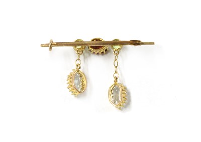 Lot 1048 - An Edwardian gold aquamarine, garnet and peridot brooch