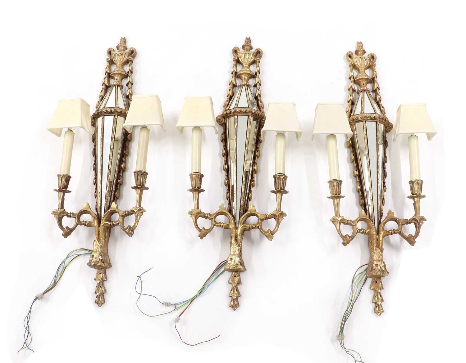 Lot 296 - A set of three gilt-composite and glass wall lights
