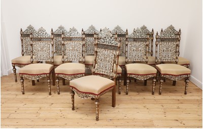 Lot 573 - A set of twelve walnut, bone and mother-of-pearl inlaid dining chairs