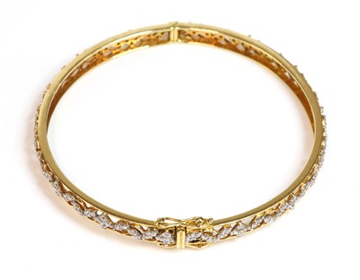 Lot 398 - An 18ct gold diamond set hinged bangle
