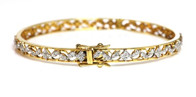 Lot 398 - An 18ct gold diamond set hinged bangle