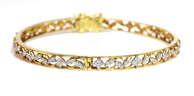 Lot 333 - An 18ct gold diamond set hinged bangle