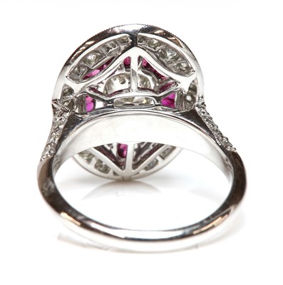 Lot 481 - An Art Deco-style platinum diamond and ruby target cluster ring