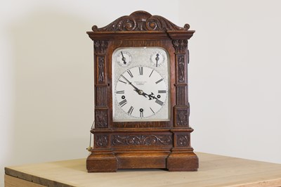 Lot 262 - A carved oak repeating bracket clock