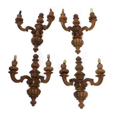 Lot 200 - A set of four carved walnut twin branch wall lights