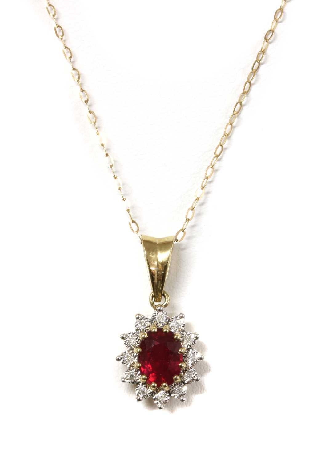 Lot 1153 - A 9ct gold fracture filled ruby and diamond cluster pendant