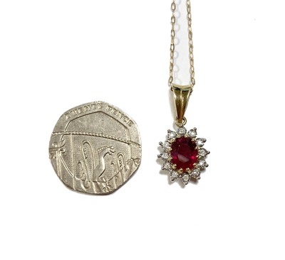 Lot 1153 - A 9ct gold fracture filled ruby and diamond cluster pendant