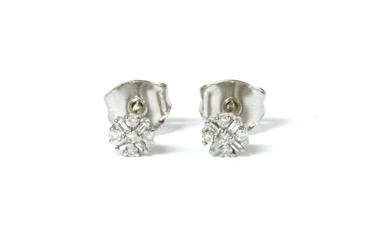 Lot 1133 - A pair of white gold diamond cluster stud earrings