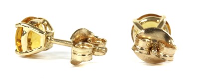 Lot 1182 - A pair of gold single stone citrine stud earrings