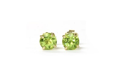 Lot 1205 - A pair of gold single stone peridot stud earrings
