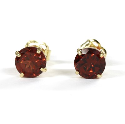 Lot 1161 - A pair of gold single stone garnet stud earrings