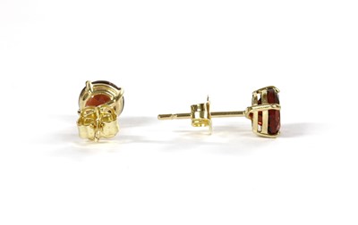Lot 1161 - A pair of gold single stone garnet stud earrings
