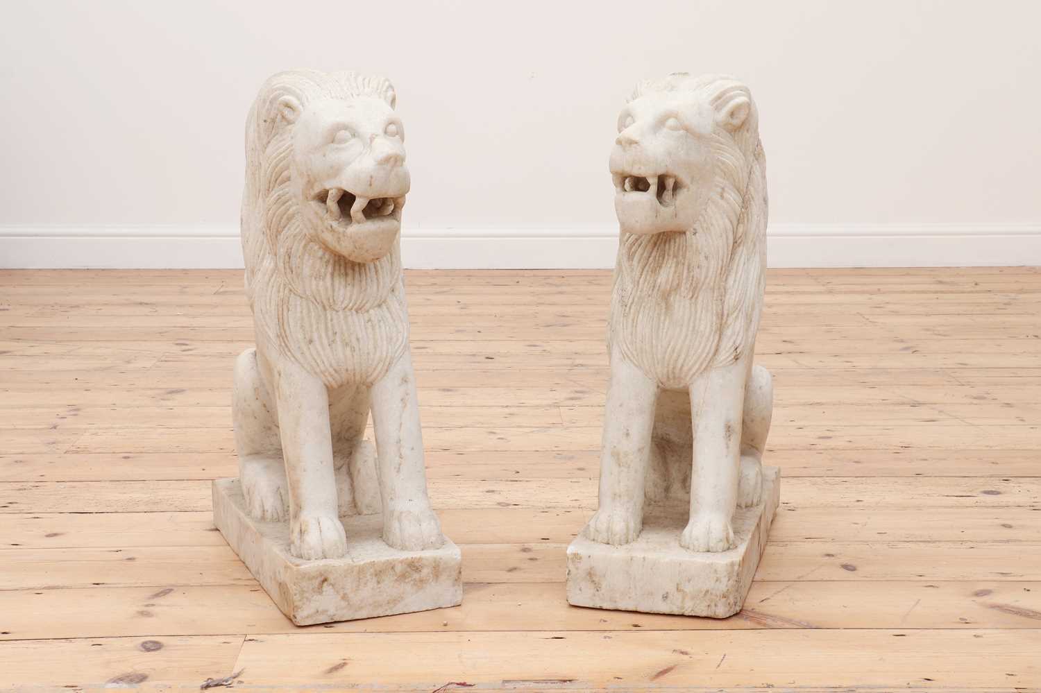 Lot 147 - A pair of marble seated lions