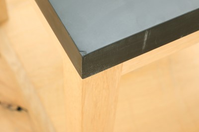 Lot 254 - A pair of contemporary slate and oak side tables